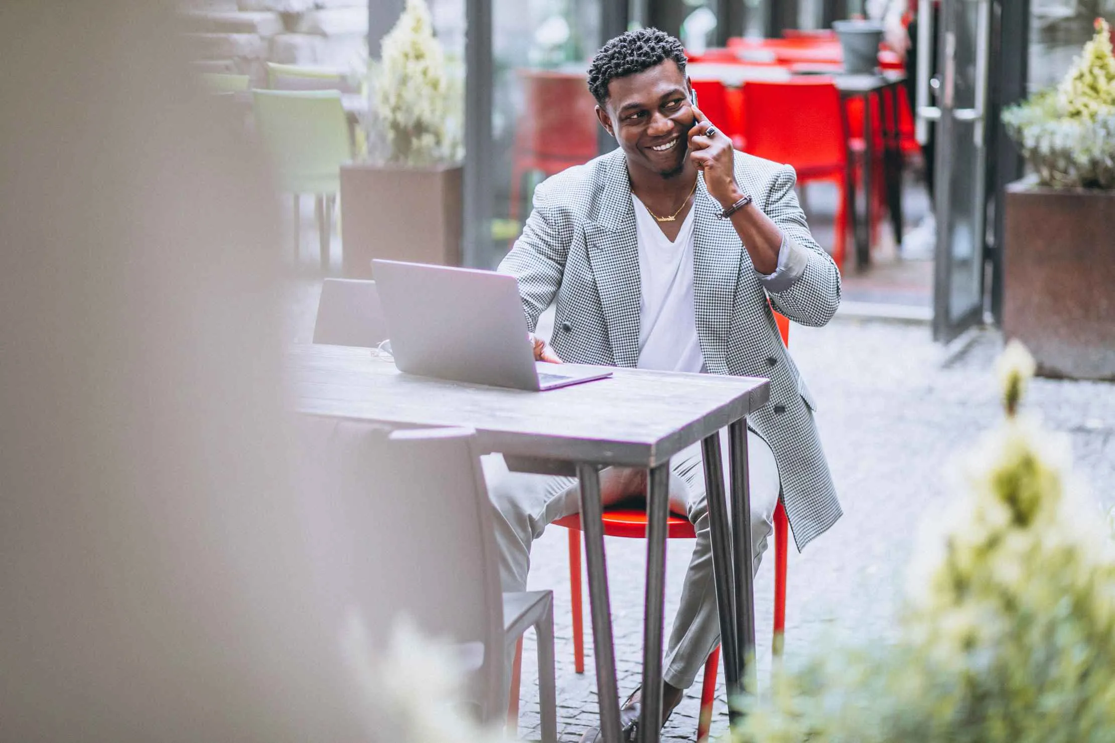African businessman using a laptop at a café — bilingual website East Africa, French website for East African businesses