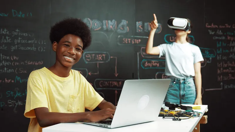 Students learning to code and use AI on laptops in a classroom