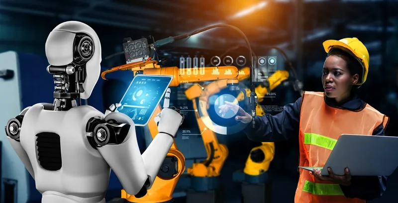 Factory worker collaborating with an industrial robot for AI workforce transformation