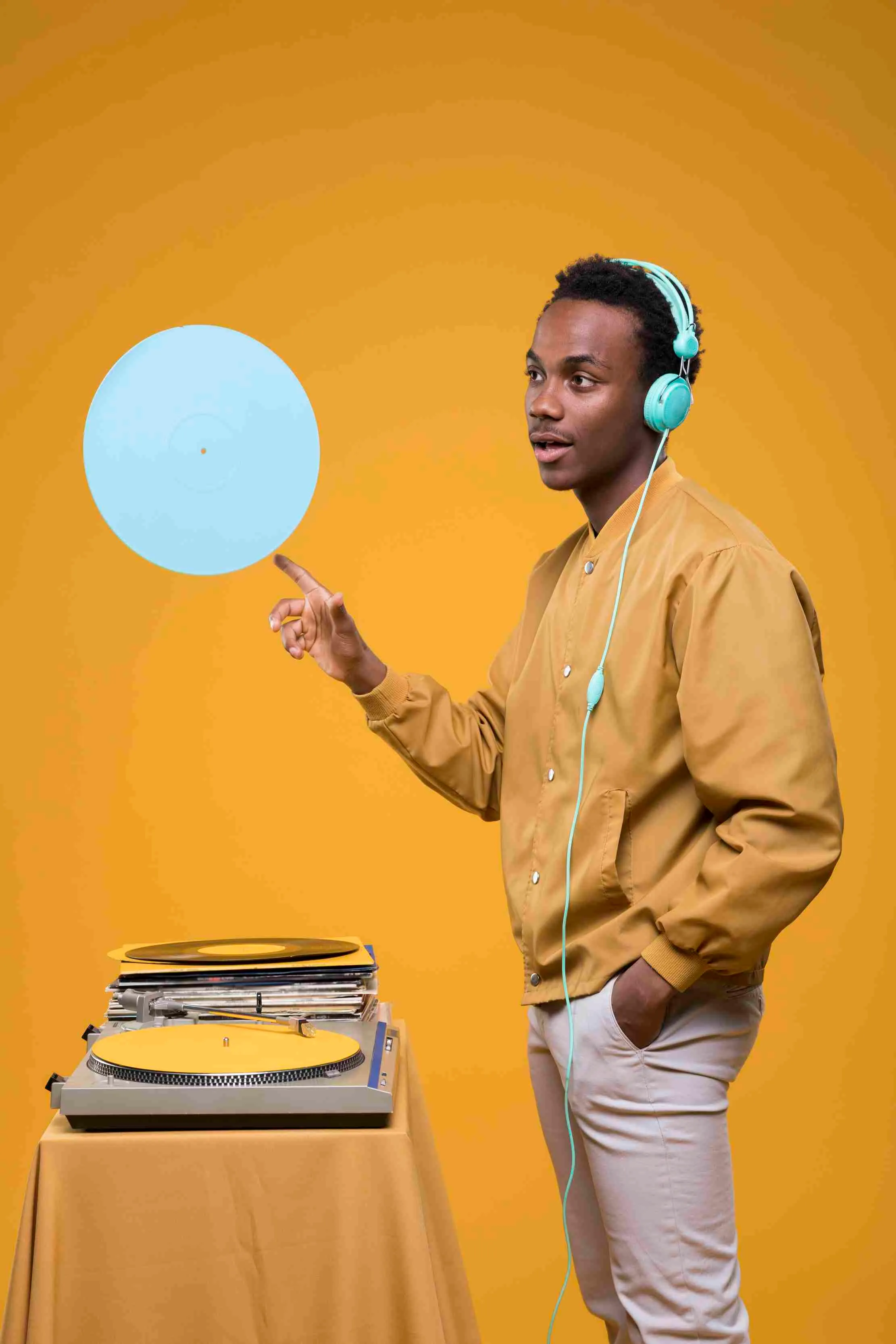 Black man posing with vinyl records — Ugandan music distribution and music download culture