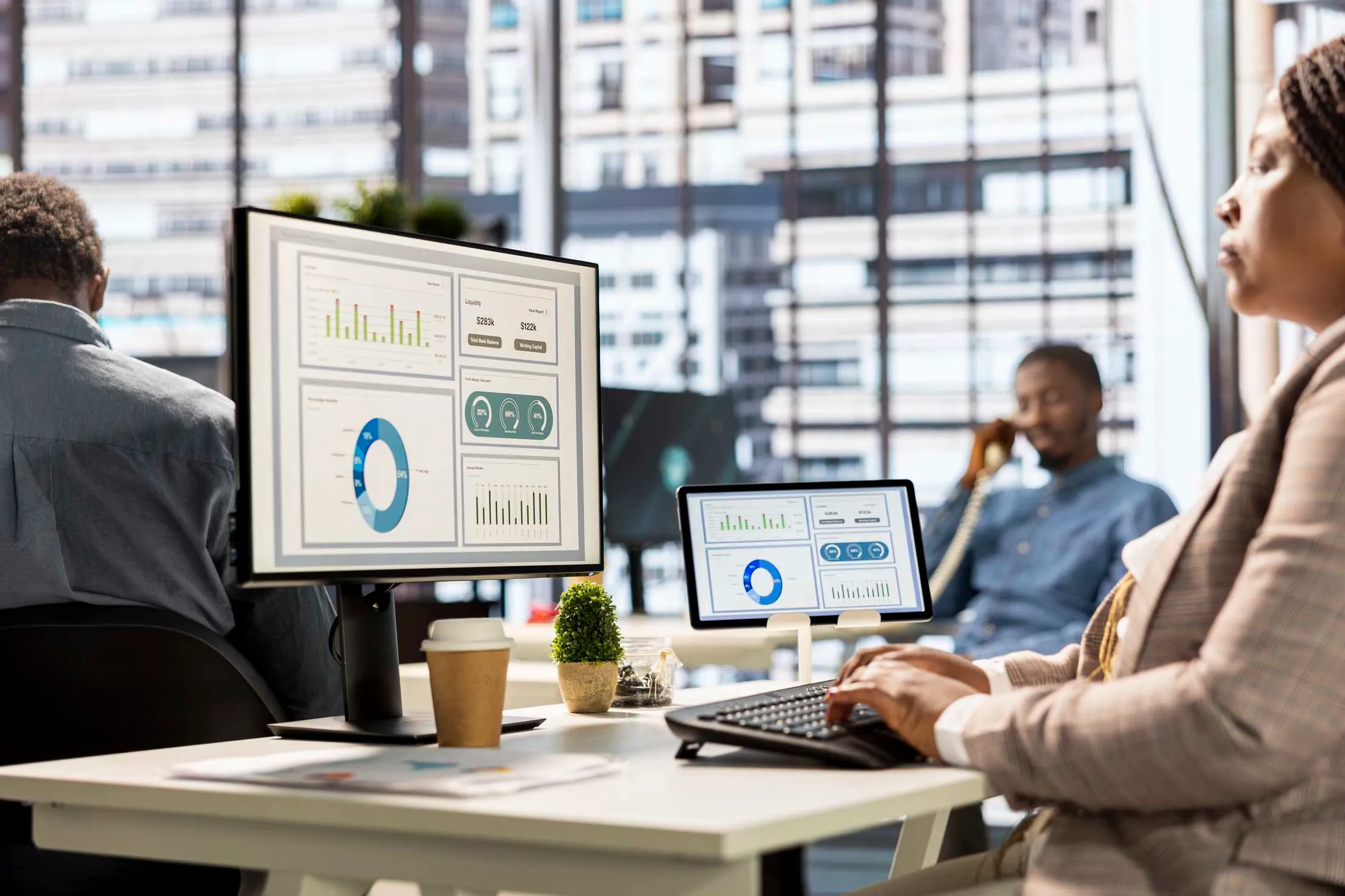 Executive reviewing infographics and KPI dashboards on screen