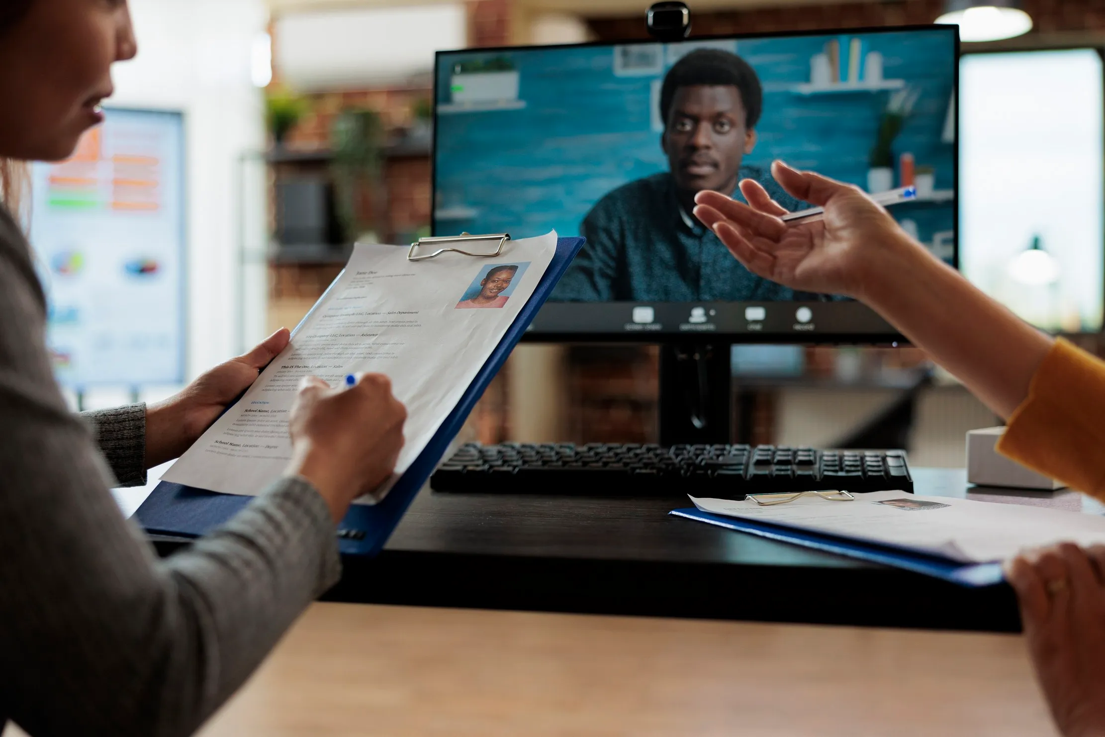 Technology leaders discussing a business decision around a large display in a collaborative office