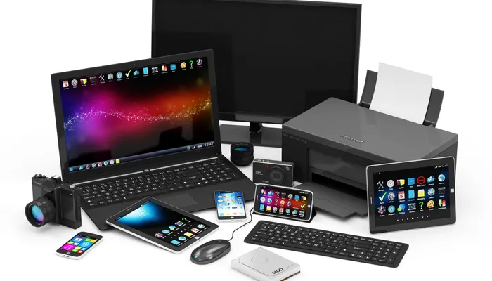 Mixed office equipment including a laptop, monitor, printer and tablet, representing a planned computer lifecycle