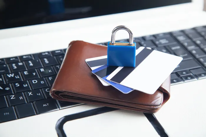 Padlock, wallet and credit cards on a keyboard, representing practical business security controls