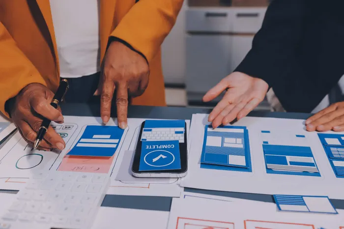 UX team designing and reviewing app interface wireframes and prototypes