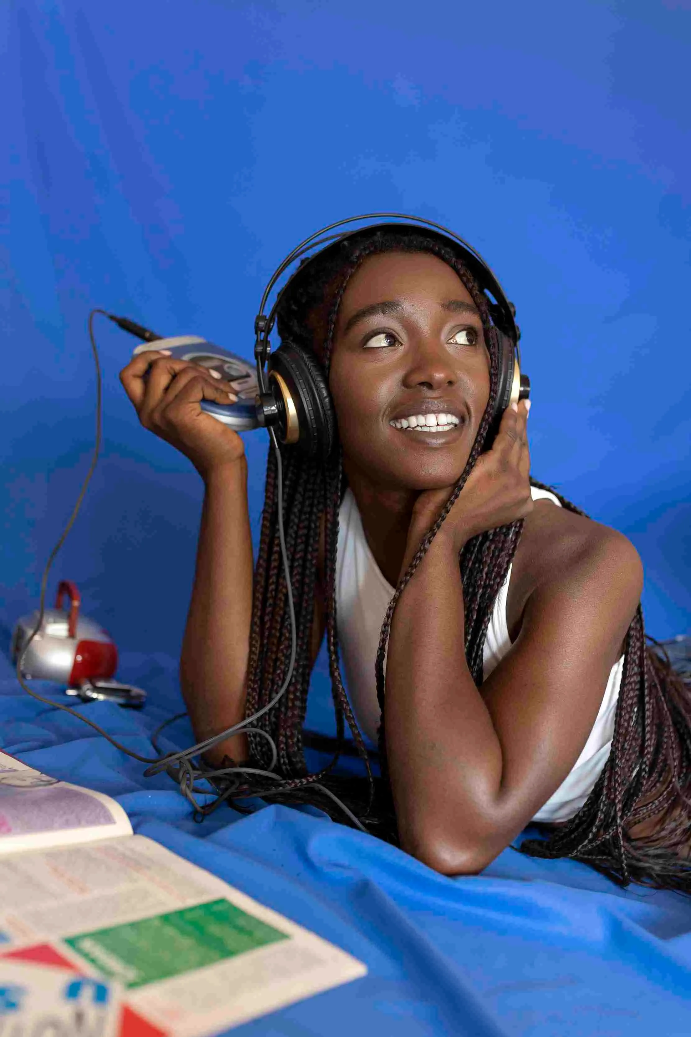 Woman wearing headphones listening to music — music streaming platforms and digital rights management Africa