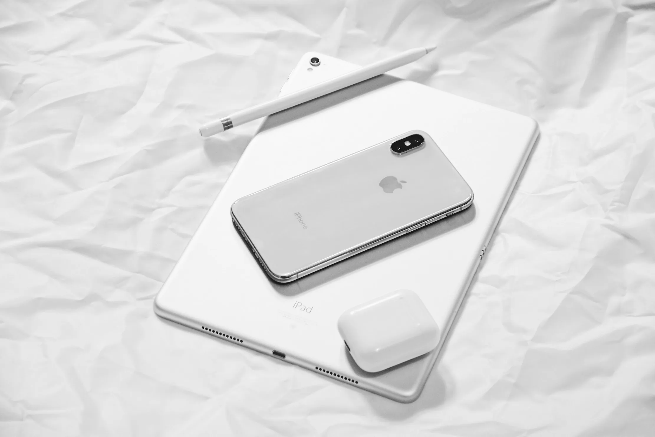 A range of iPhone, iPad, and Apple accessories on a white table