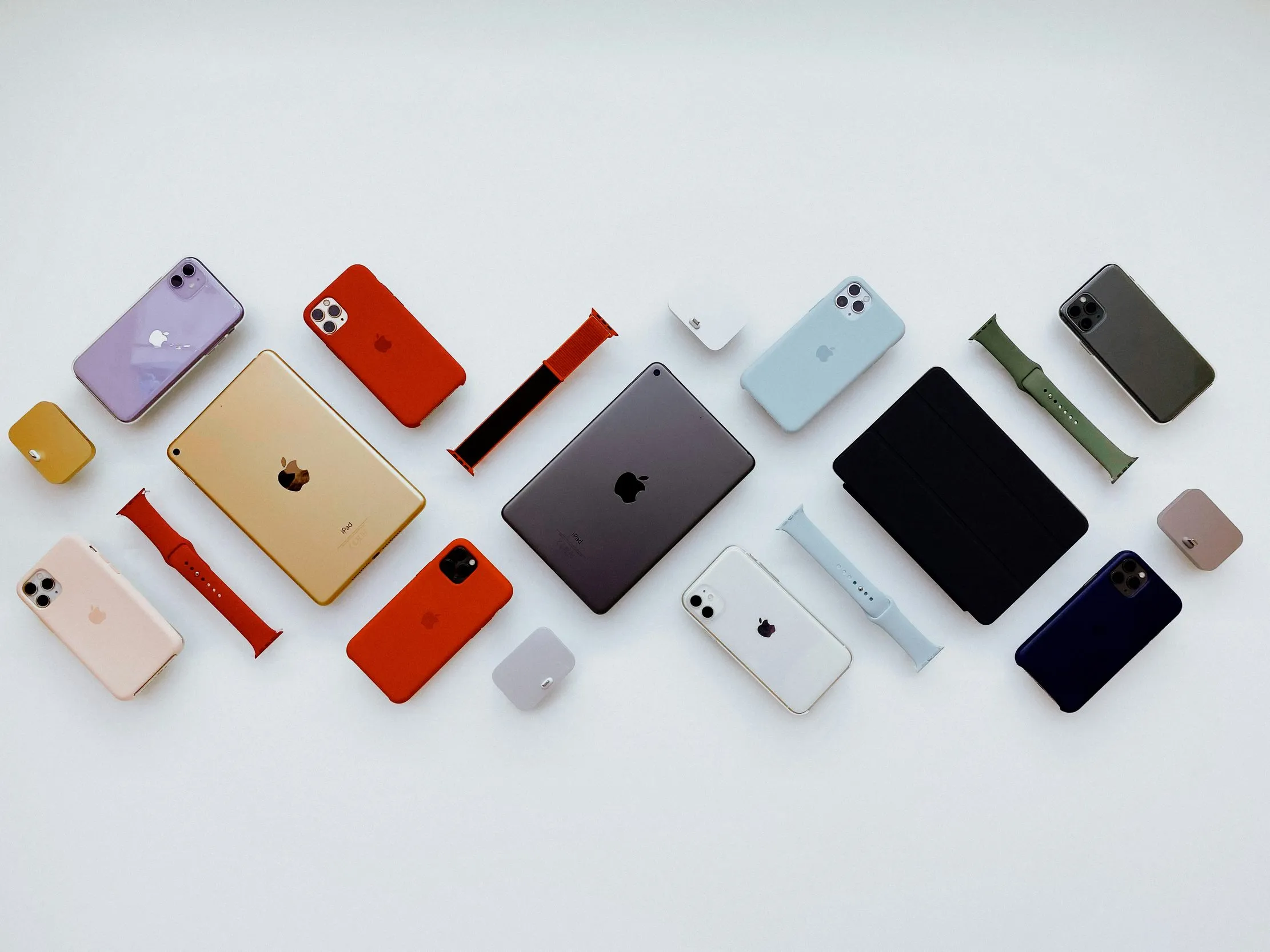iPhone, iPad, Apple Watch, and Apple accessories arranged on a white background