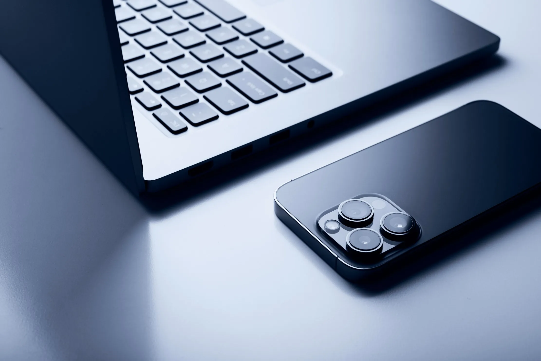 MacBook and iPhone on a desk, representing the move to Xcode 27 on Apple Silicon